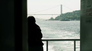 Silhouette on Ferry with Istanbul Bridge View