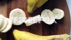 sliced bananas on a wooden cutting board