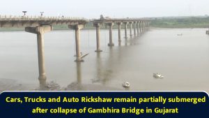 Cars, Trucks and Auto Rickshaw remain partially submerged after collapse of Gambhira Bridge in Gujarat