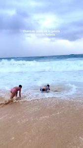 Women Get Knocked Down by Large Wave While in Water
