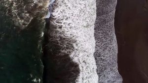 aerial view of waves crashing ashore