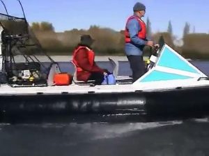 Hovercraft on a stony river against the flow